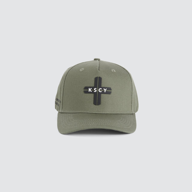 model wears Charon 5 Panel Curved Peak Cap Vetiver Caps Green - image 1