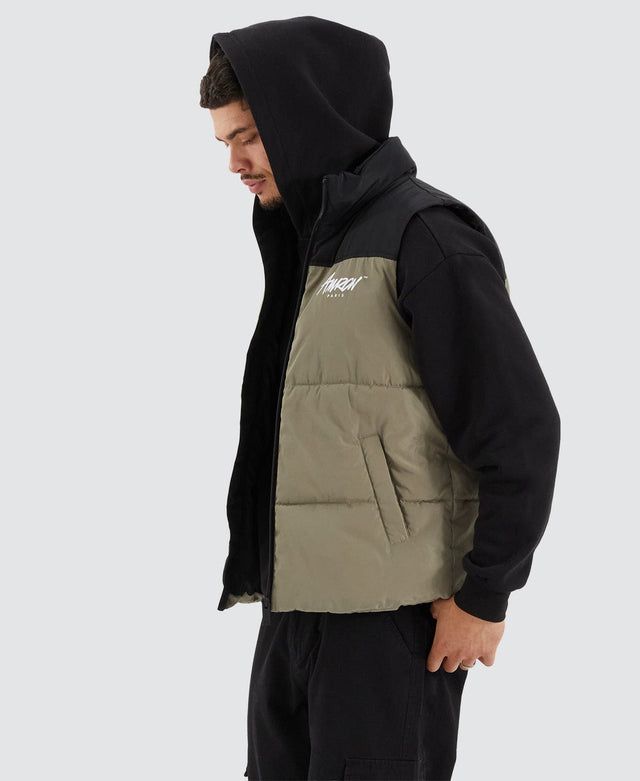 model wears Caldas Puffer Vest Jet Black/Khaki Vests Green - image 4