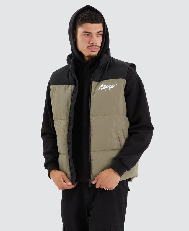 model wears Caldas Puffer Vest Jet Black/Khaki Vests Green - image 1