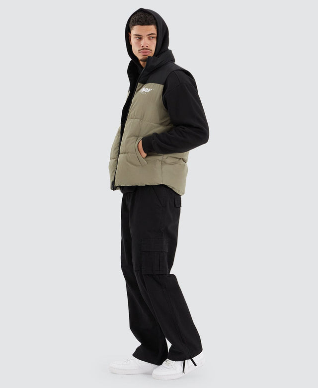 model wears Caldas Puffer Vest Jet Black/Khaki Vests Green - image 3