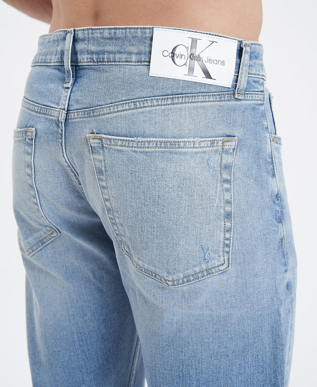 Relaxed fit Slim Taper Jeans in light blue with signature Calvin Klein logo