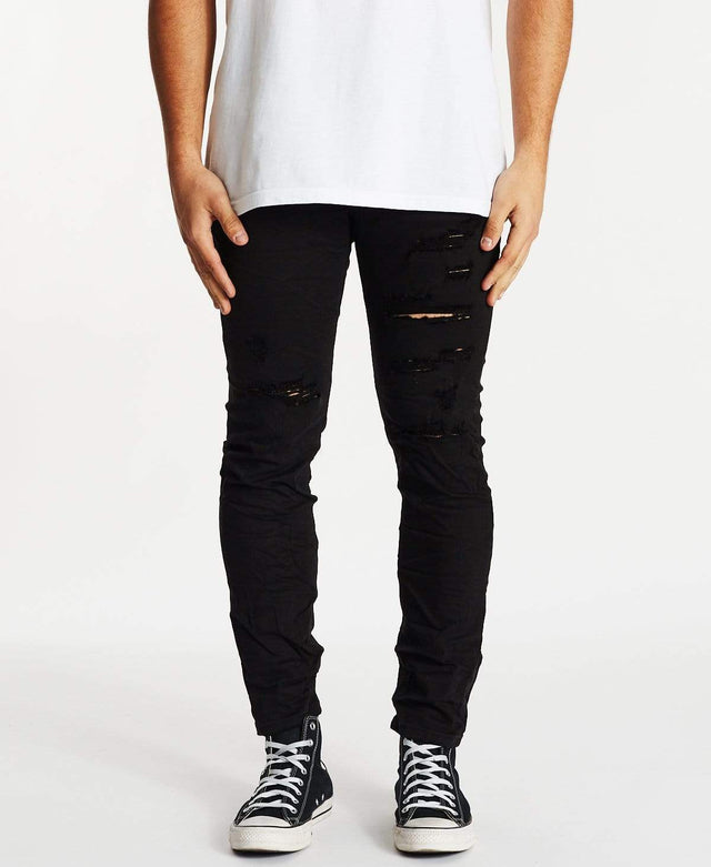 model wears K2 Skinny Jean Destroyed Black Pants Black - image 1