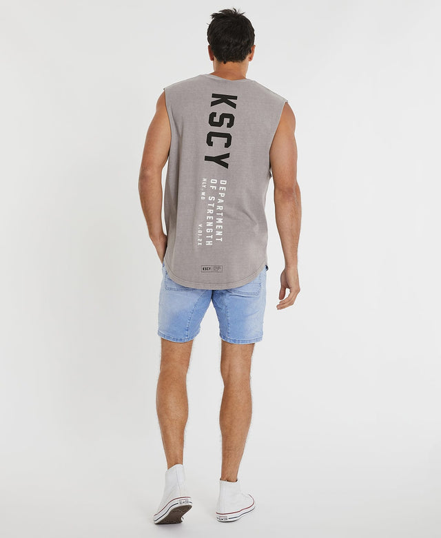 Man wearing relaxed fit, grey muscle tee by Kiss Chacey, adorned with contrasting black and white logo prints.