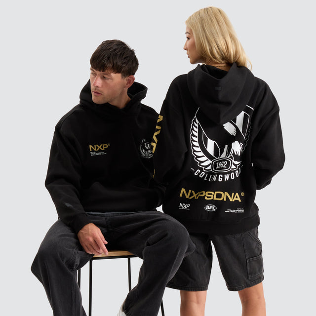 model wears Collingwood Magpies AFL Relaxed Hoodie Jet Black Hoodies Black - image 2