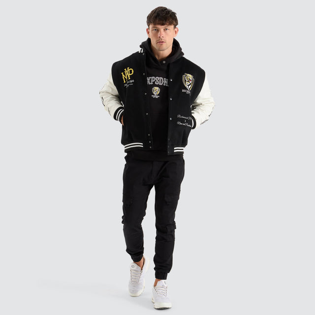 model wears Richmond Tigers AFL Varsity Jacket Jet Black Jackets Black - image 4