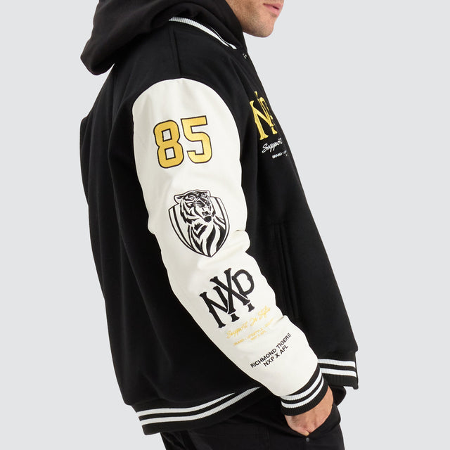 model wears Richmond Tigers AFL Varsity Jacket Jet Black Jackets Black - image 2