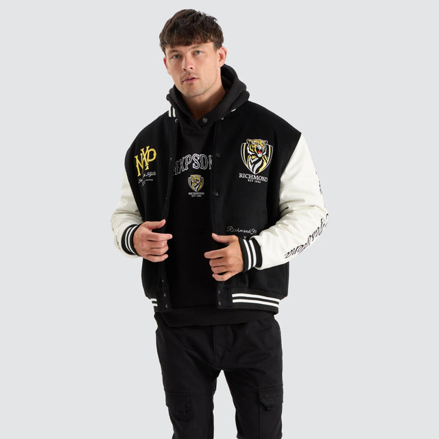 model wears Richmond Tigers AFL Varsity Jacket Jet Black Jackets Black - image 1