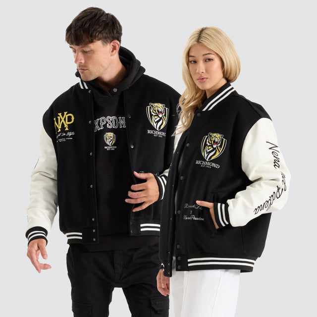 model wears Richmond Tigers AFL Varsity Jacket Jet Black Jackets Black - image 3