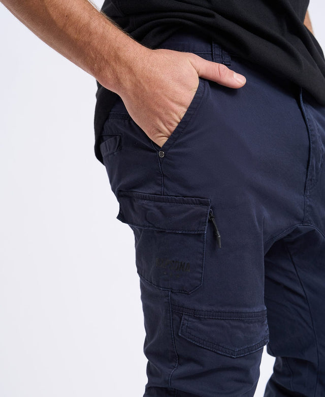 Slim fit jogger cargo pants in navy blue by NXP, with zipped-flap pockets and an elastic cuff hem