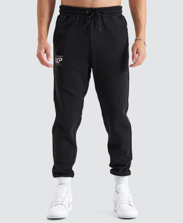 model wears Gambit Slim Trackpant Jet Black Trackpants Black - image 2