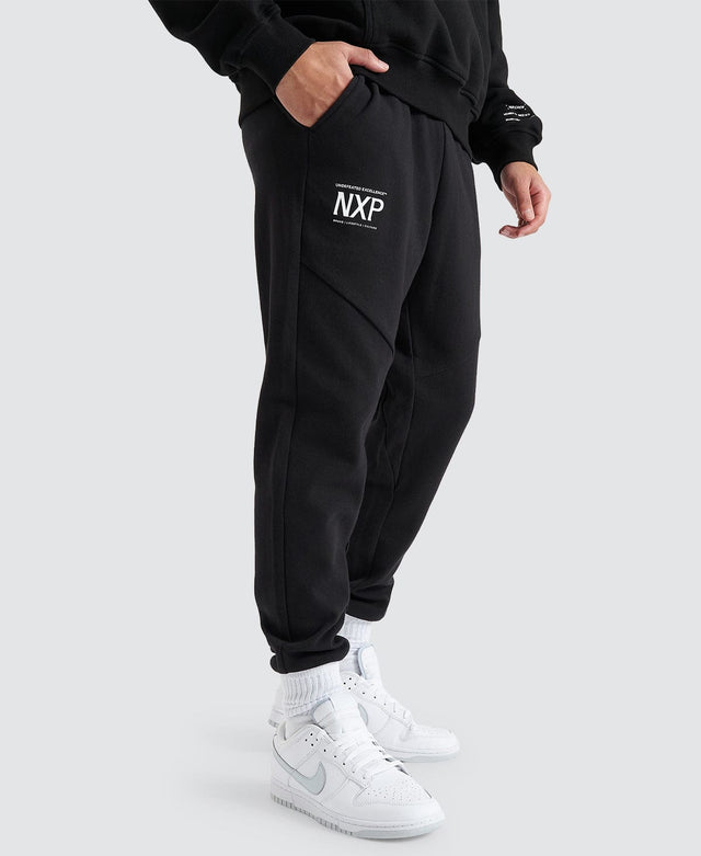 model wears Gambit Slim Trackpant Jet Black Trackpants Black - image 1