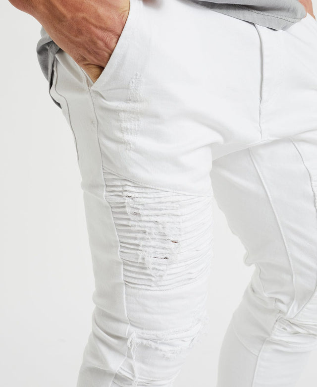 Men’s denim pants in white with distressed details, drop crotch on front and back gusset designed by Nena Pasadena