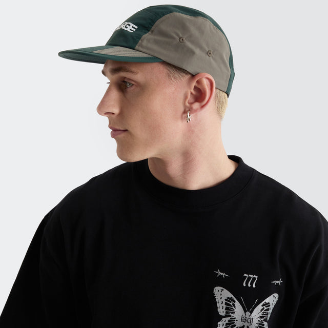 model wears Two Thousand Camp Cap Grey/Forest Headwear Grey - image 2