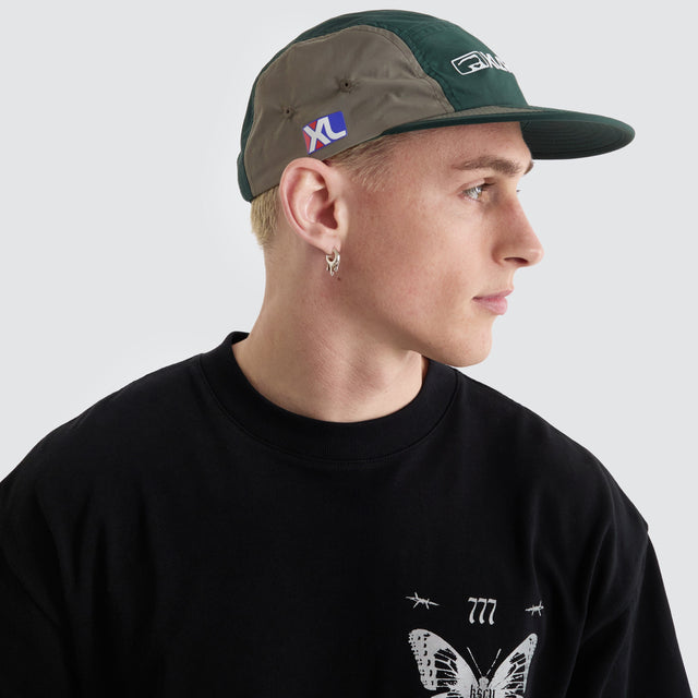 model wears Two Thousand Camp Cap Grey/Forest Headwear Grey - image 3