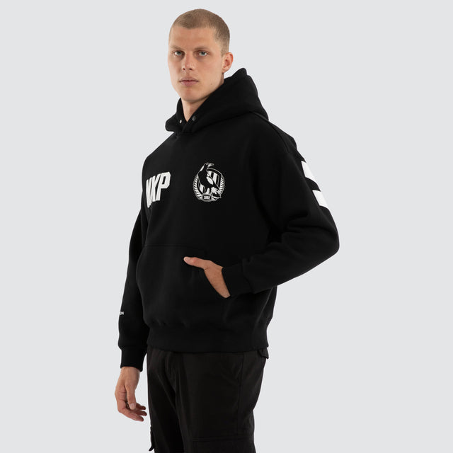 Model wears Collingwood Magpies AFL Top Tier Hoodie Jet Black Hoodies Black – image 4