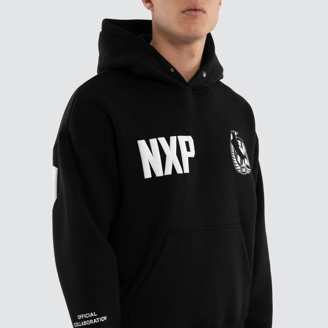 Model wears Collingwood Magpies AFL Top Tier Hoodie Jet Black Hoodies Black – image 5