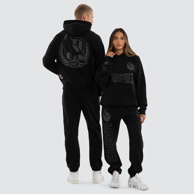 Model wears Collingwood Magpies AFL Persistent Hoodie Jet Black Hoodies Black – image 3