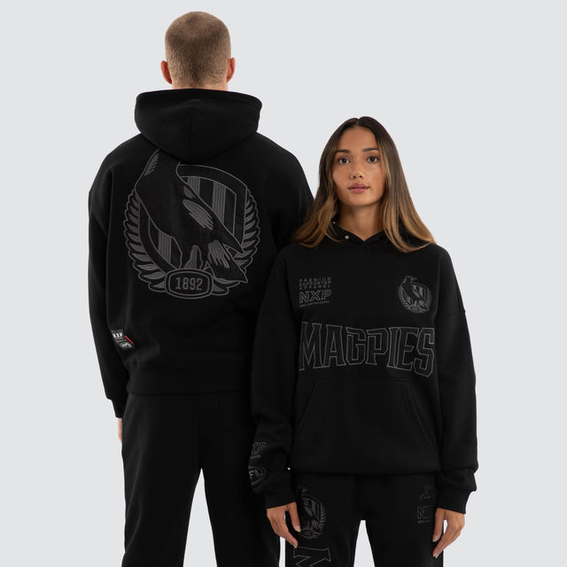 Model wears Collingwood Magpies AFL Persistent Hoodie Jet Black Hoodies Black – image 1