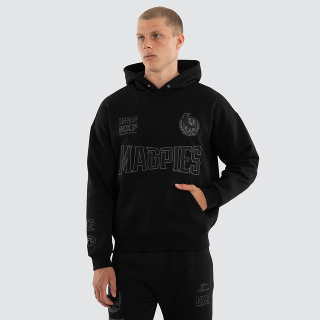 Model wears Collingwood Magpies AFL Persistent Hoodie Jet Black Hoodies Black – image 2