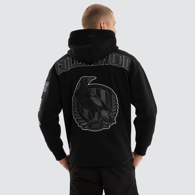 Model wears Collingwood Magpies AFL Simulation Hoodie Jet Black Hoodies Black – image 1