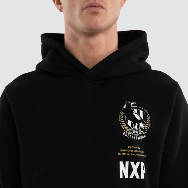 Model wears Collingwood Magpies AFL Trophy Dual Curved Hoodie Jet Black Hoodies Black – image 5