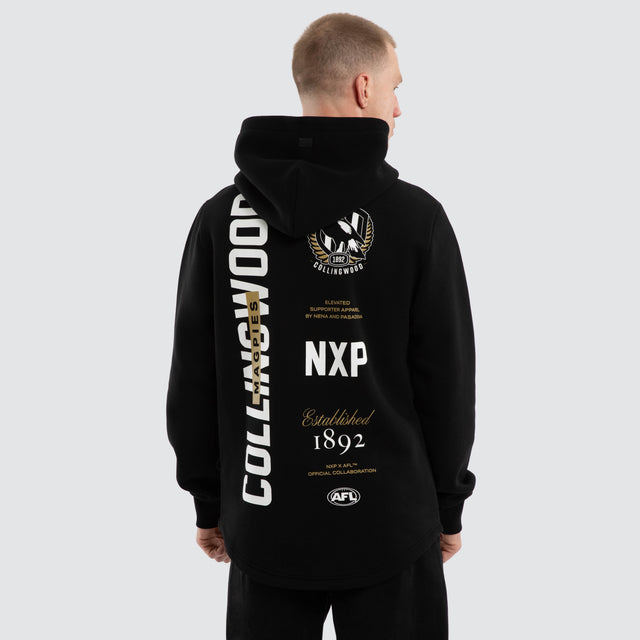 Model wears Collingwood Magpies AFL Trophy Dual Curved Hoodie Jet Black Hoodies Black – image 1