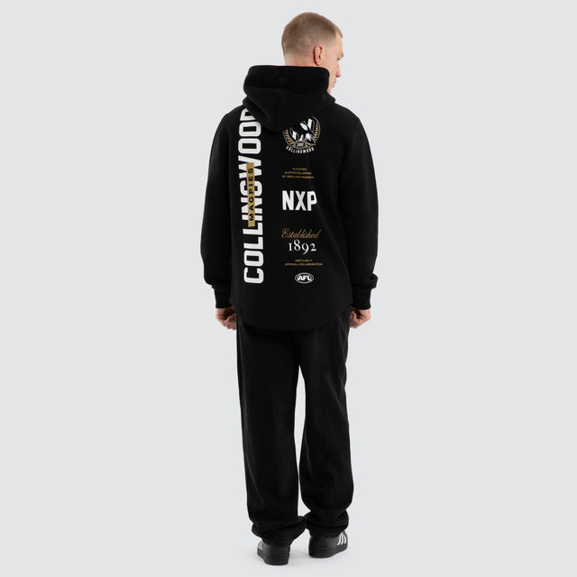 Model wears Collingwood Magpies AFL Trophy Dual Curved Hoodie Jet Black Hoodies Black – image 3