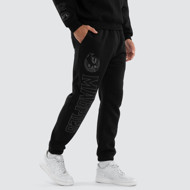 Model wears Collingwood Magpies AFL Perform Trackpant Jet Black Trackpants Black – image 2