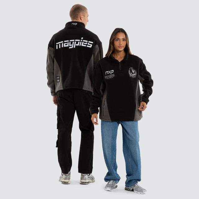 Model wears Collingwood Magpies AFL Defence Pullover Black/Charcoal Jumpers Black – image 3