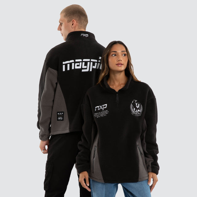 Model wears Collingwood Magpies AFL Defence Pullover Black/Charcoal Jumpers Black – image 1