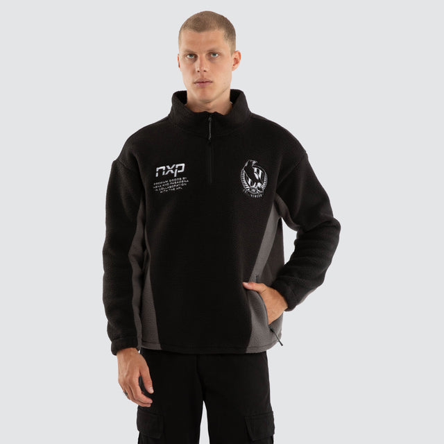 Model wears Collingwood Magpies AFL Defence Pullover Black/Charcoal Jumpers Black – image 2