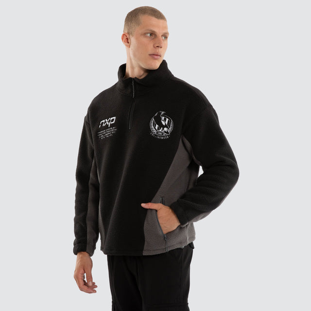 Model wears Collingwood Magpies AFL Defence Pullover Black/Charcoal Jumpers Black – image 5