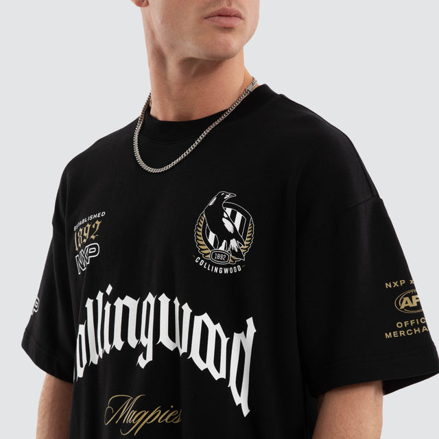 Model wears Collingwood Magpies AFL Gold Raptor Tee Jet Black T-Shirts Black – image 6