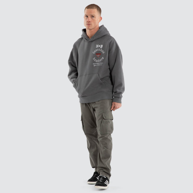 Model wears Essendon Bombers AFL Tag Box Fit Hoodie Charcoal Hoodies Grey – image 2