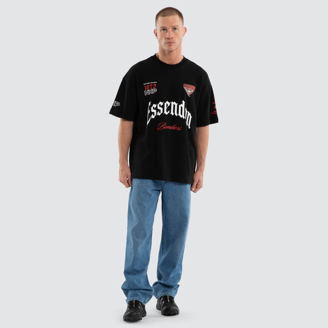 Model wears Essendon Bombers AFL Gold Raptor Tee Jet Black T-Shirts Black – image 4