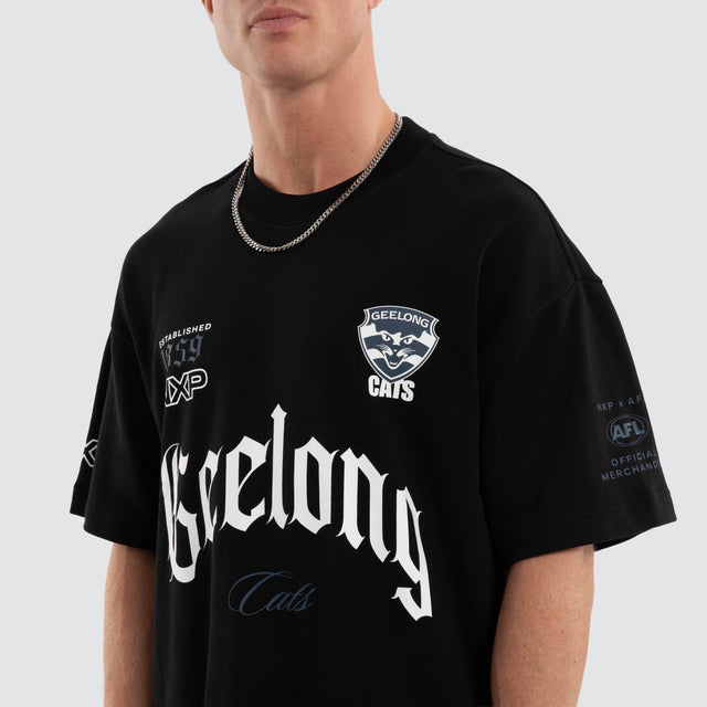 Model wears Geelong Cats AFL Gold Raptor Tee Jet Black T-Shirts Black – image 6