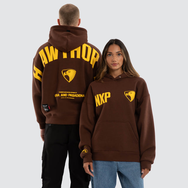 Model wears Hawthorn Hawks AFL Top Tier Hoodie Brown Hoodies Brown – image 1