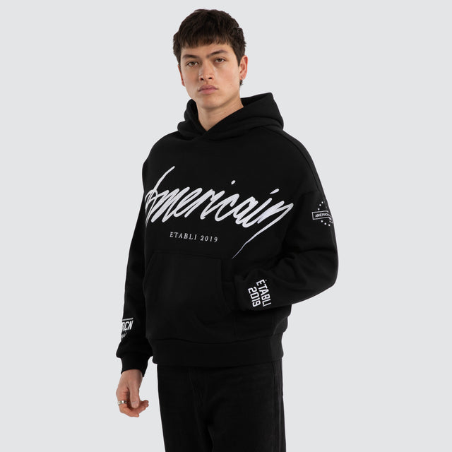 Model wears Legend Relaxed Hoodie Jet Black/White Hoodies Black – image 1