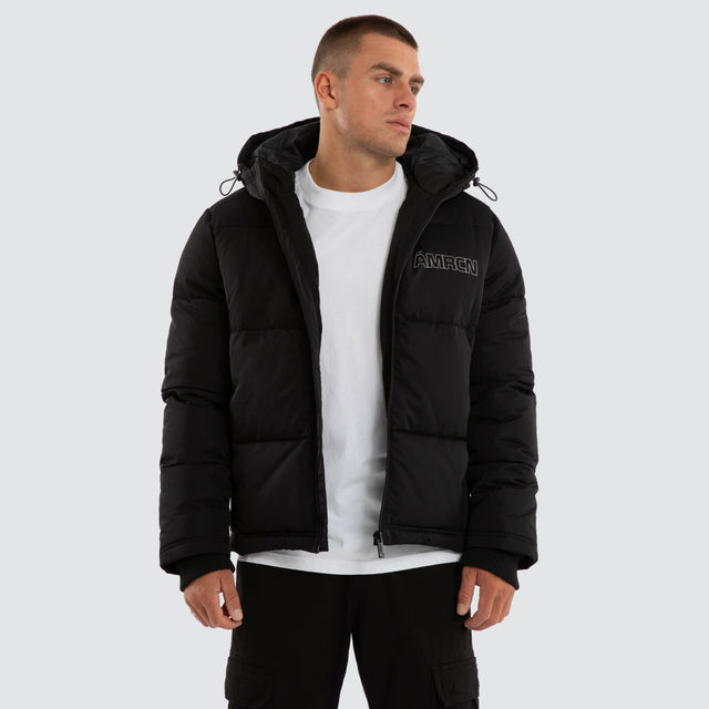 Model wears Vector Hooded Puffer Jacket Jet Black Jackets Black – image 1