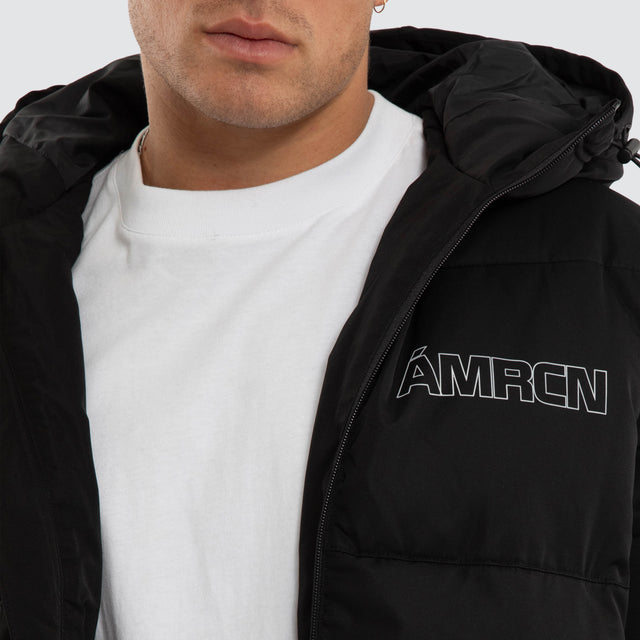 Model wears Vector Hooded Puffer Jacket Jet Black Jackets Black – image 4