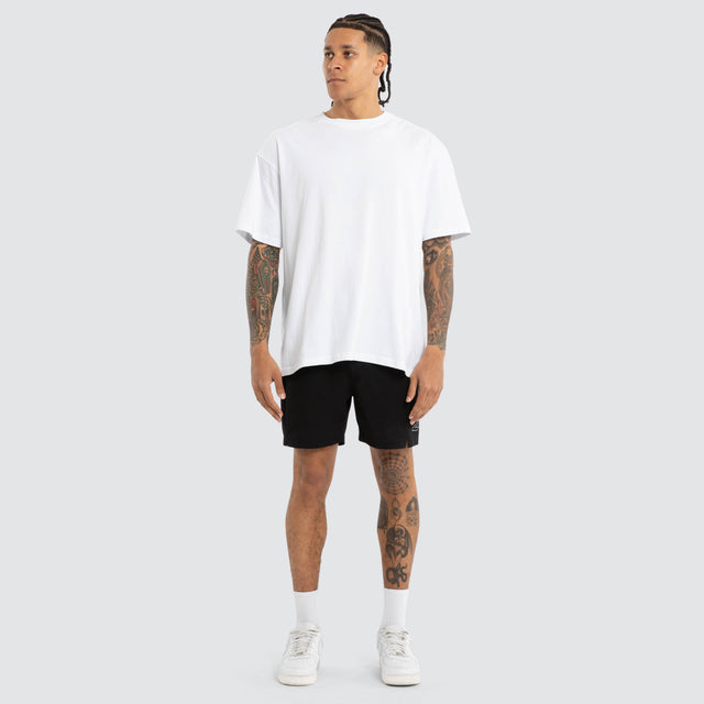 Model wears Grima Beach Short Jet Black/White Shorts Black – image 3