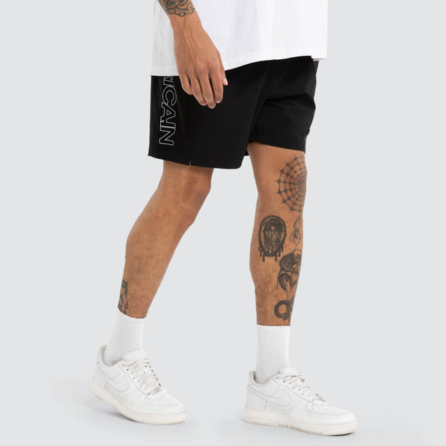 Model wears Grima Beach Short Jet Black/White Shorts Black – image 2
