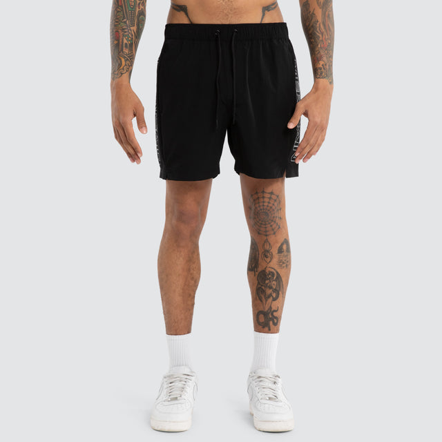 Model wears Grima Beach Short Jet Black/White Shorts Black – image 6