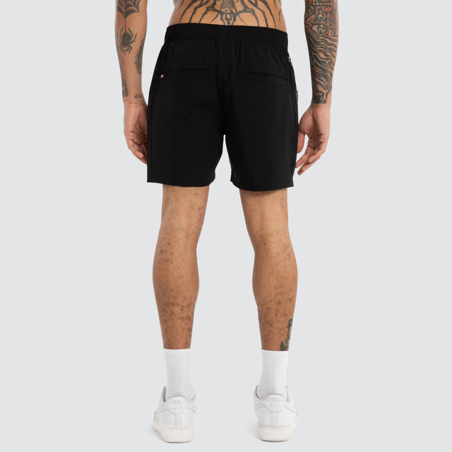Model wears Grima Beach Short Jet Black/White Shorts Black – image 4