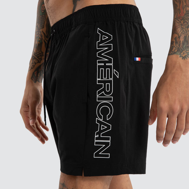 Model wears Grima Beach Short Jet Black/White Shorts Black – image 5