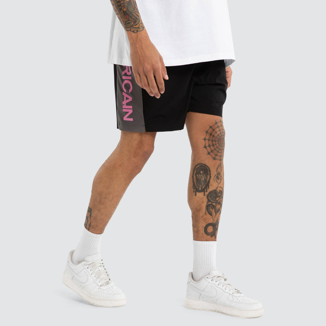Model wears Grima Beach Short Jet Black/Pink Shorts Black – image 3
