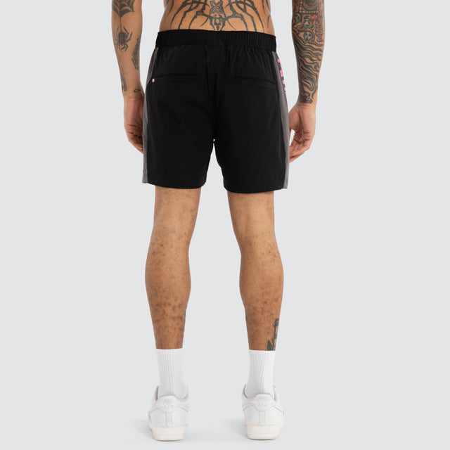 Model wears Grima Beach Short Jet Black/Pink Shorts Black – image 6