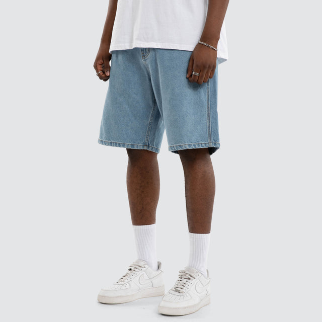 Model wears Dillon Denim Jort Mid Blue Shorts Blue – image 1