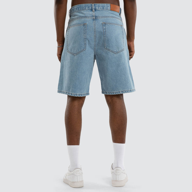 Model wears Dillon Denim Jort Mid Blue Shorts Blue – image 4