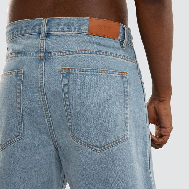 Model wears Dillon Denim Jort Mid Blue Shorts Blue – image 5